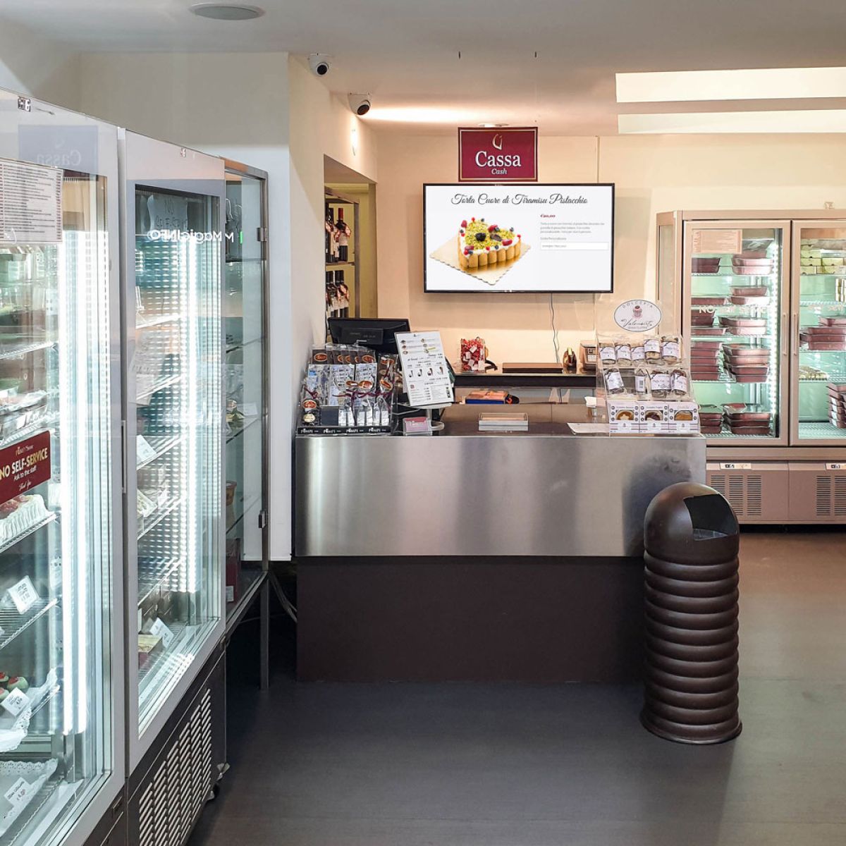 Samsung display Smart Signage installato a parete dietro in bancone della pasticceria