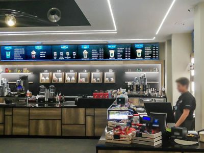 Videowall Samsung Smart Signage con menu prodotti installati a parete all'interno del bar caffetteria